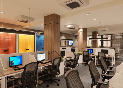 Bright and spacious modern open office interior with workstations and colorful elements.
