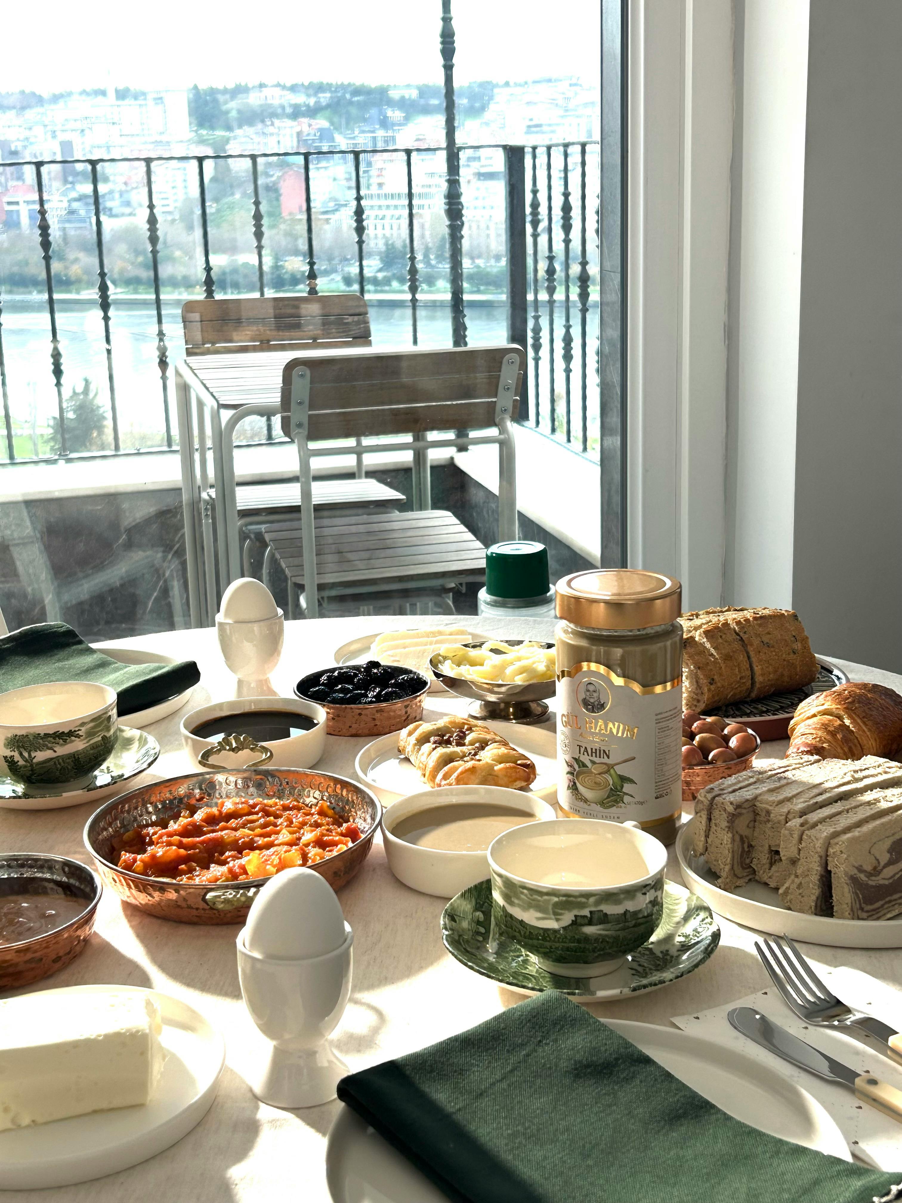Elegant breakfast spread by a window overlooking the cityscape.