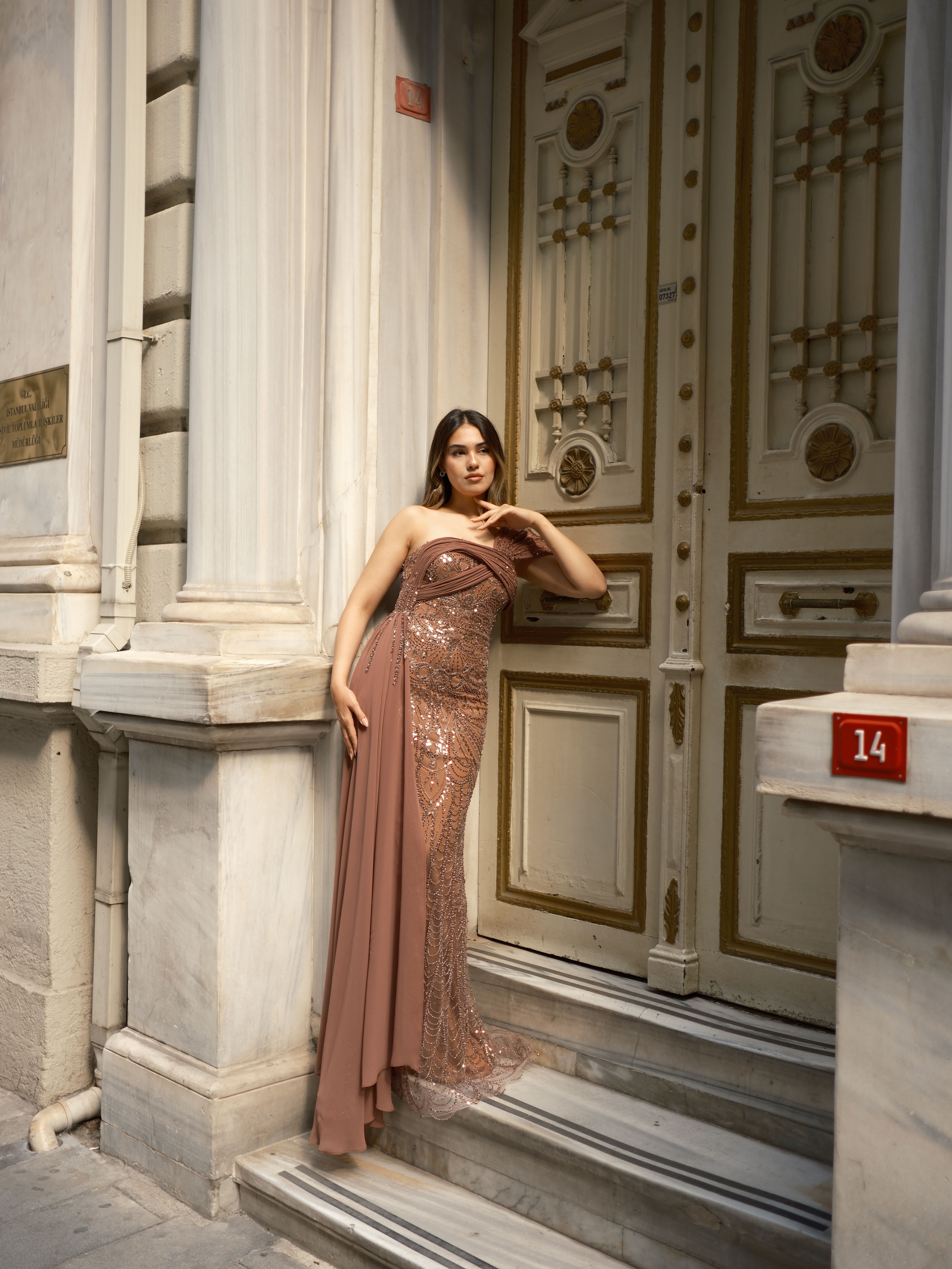 Elegant Woman in Sequin Dress by Ornate Door