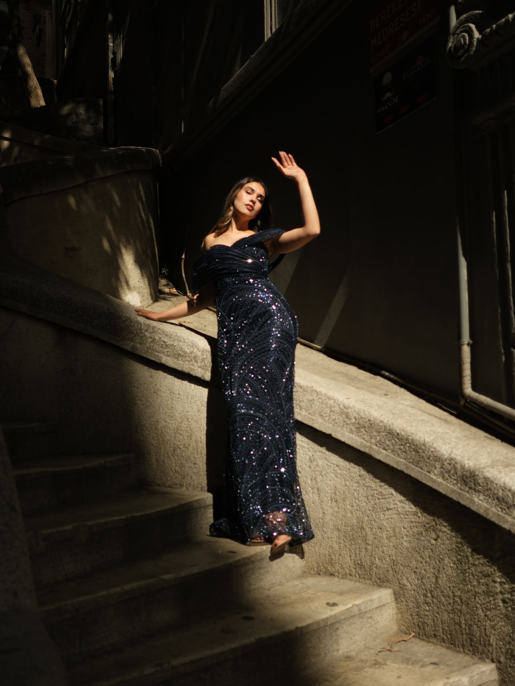 Woman in an evening gown on a dramatic staircase