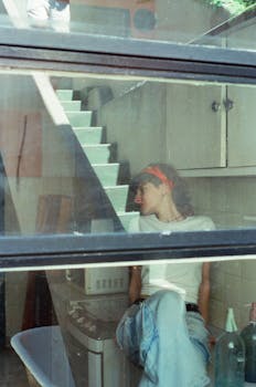 Young woman in casual wear relaxing inside an apartment in Buenos Aires, Argentina.
