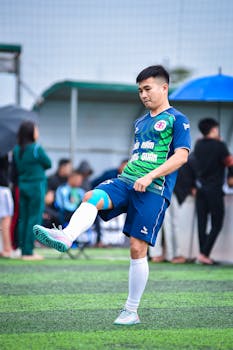 A young soccer player practicing on artificial turf field in Hanoi, Vietnam.