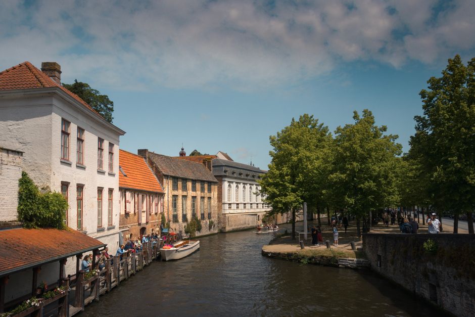 A scenic canal boat tour in Bruges, Belgium, passing historic buildings