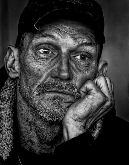 Man in Black Cap Grayscale Photo