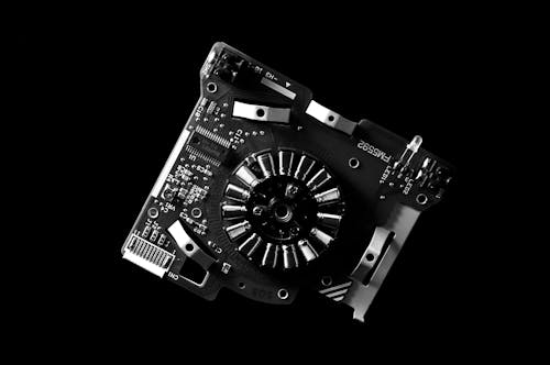 Greyscale Photo of Machine Part and Mother Board