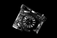 Greyscale Photo of Machine Part and Mother Board