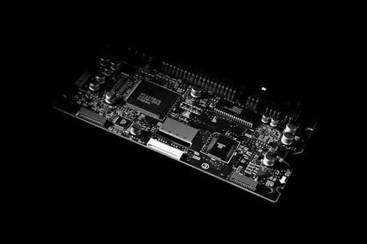 Detailed black and white image of a computer circuit board, showcasing technology components.