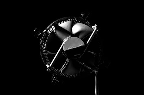 Black and White Photo of a Metal Fan 