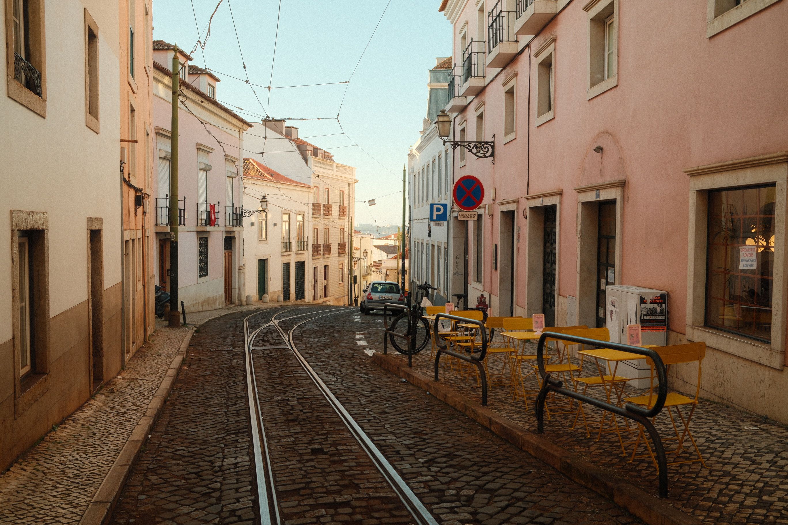 Stepped alley in Alfama with washing lines strung between tiled houses