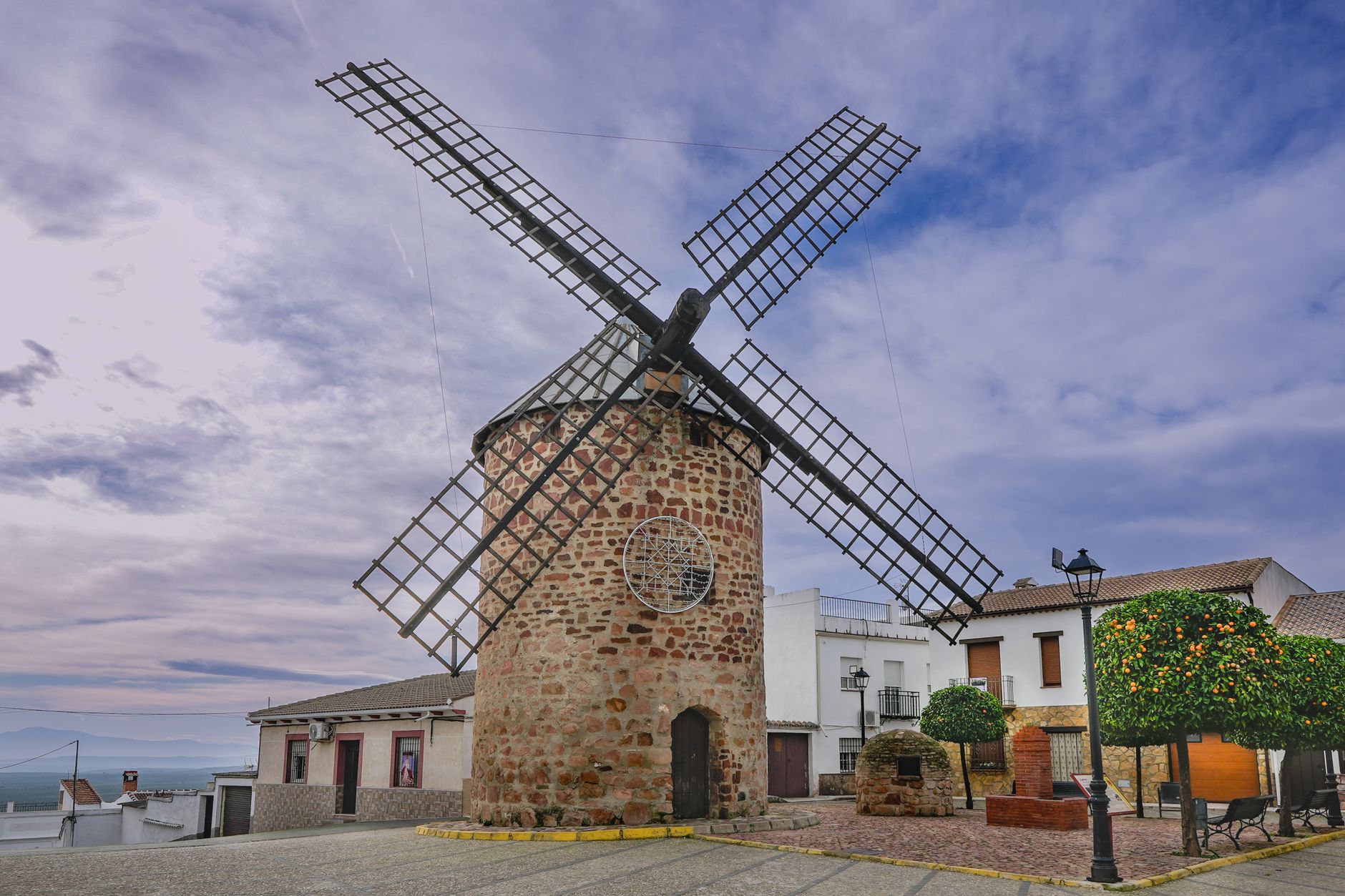 Beautiful old windmill in Baños de la Encina, Andalucía, surrounded by charming village scenery.