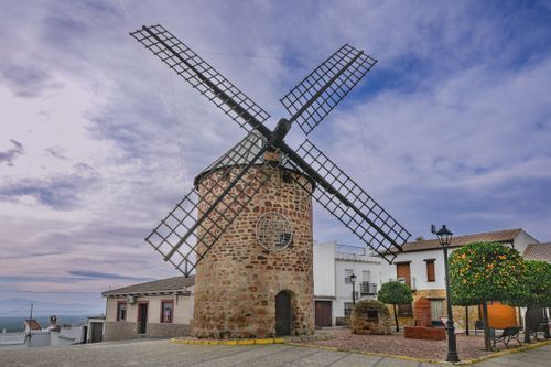 Free Beautiful old windmill in Baños de la Encina, Andalucía, surrounded by charming village scenery. Stock Photo