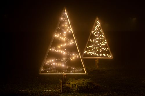 Free Elegant triangle-shaped Christmas lights in a foggy nighttime setting in Garešnica, Croatia. Stock Photo