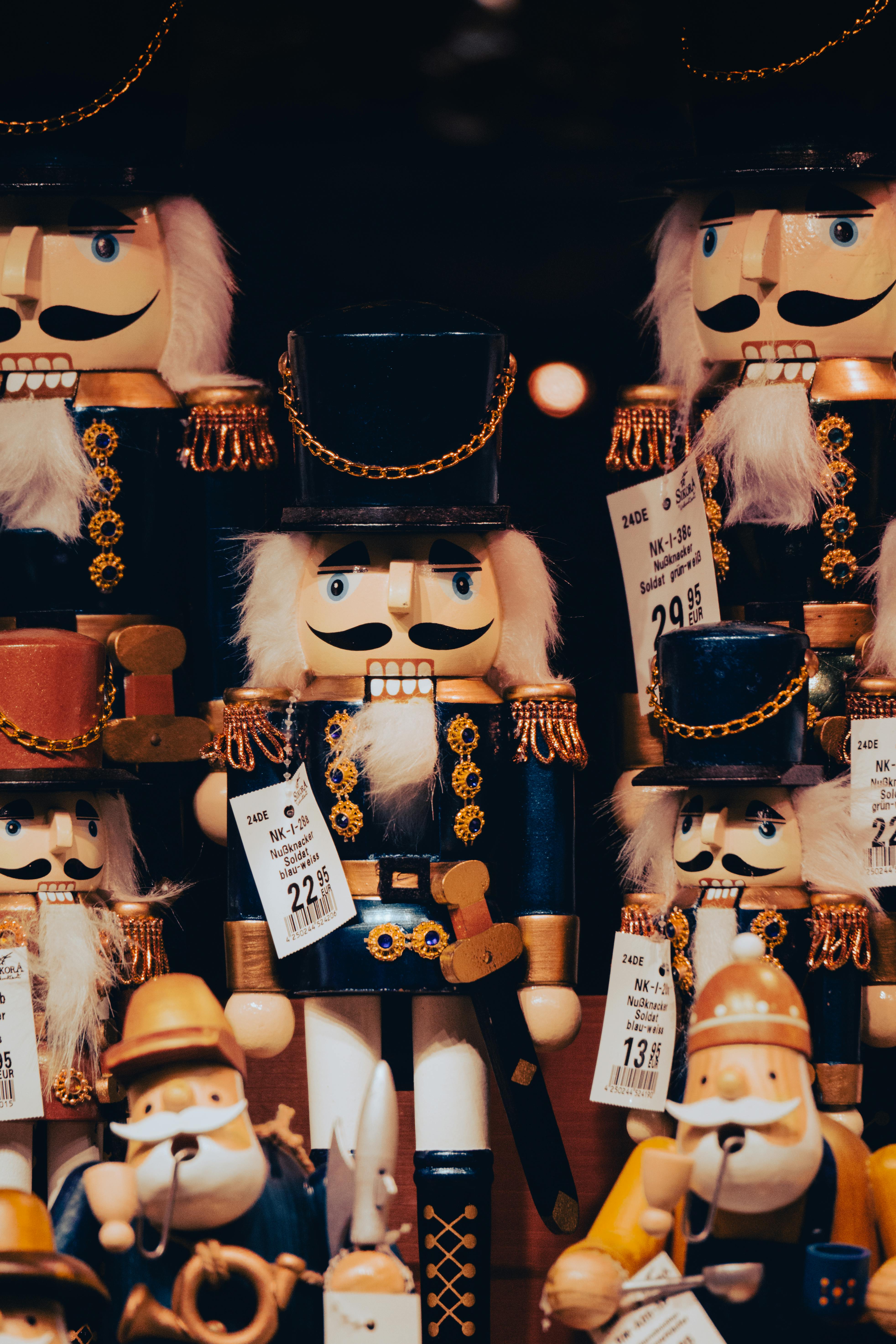 Colorful wooden nutcracker soldiers displayed with price tags, ideal for festive decoration.