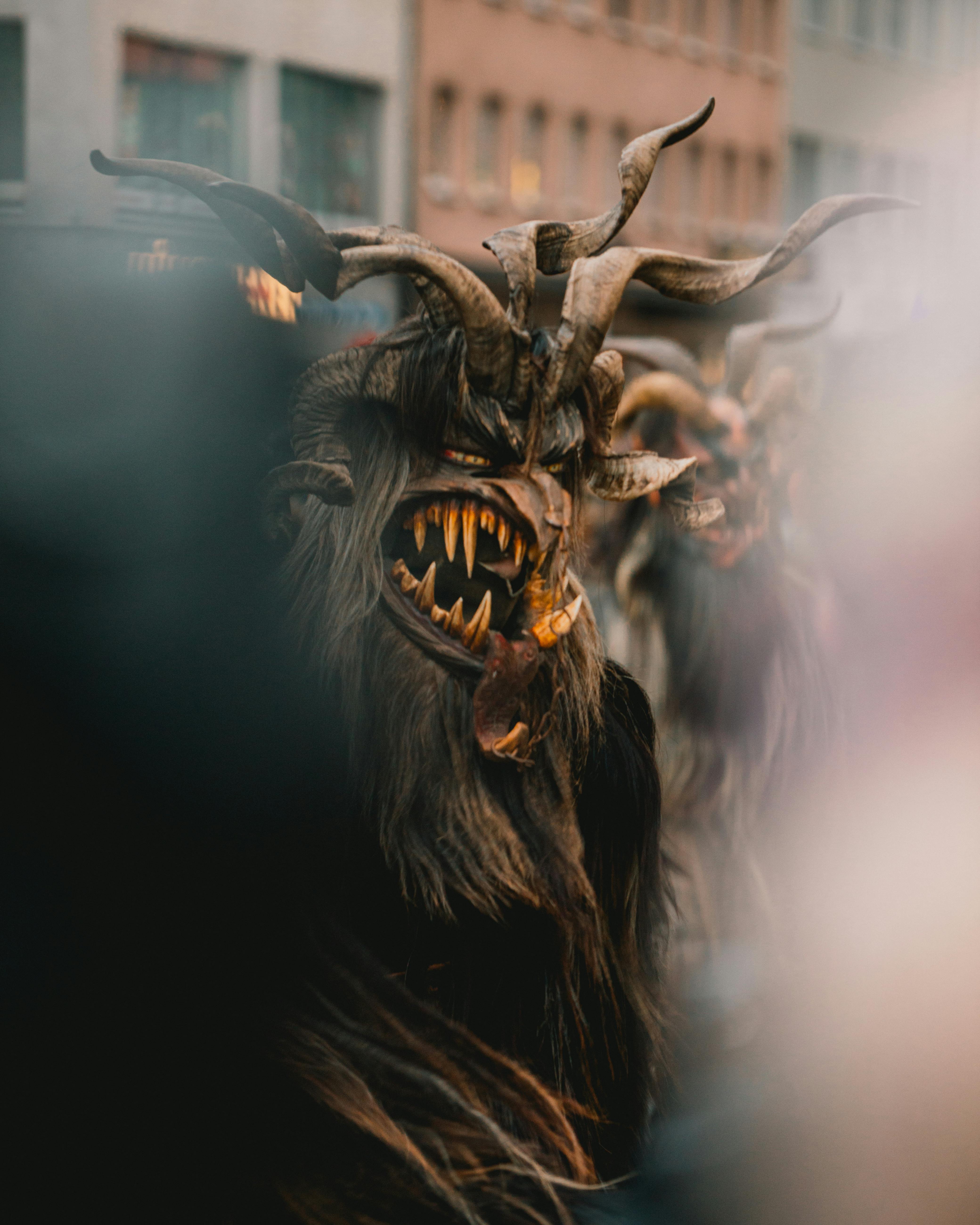 Close-up of Krampus masks in a parade, capturing the dark and mythical tradition.
