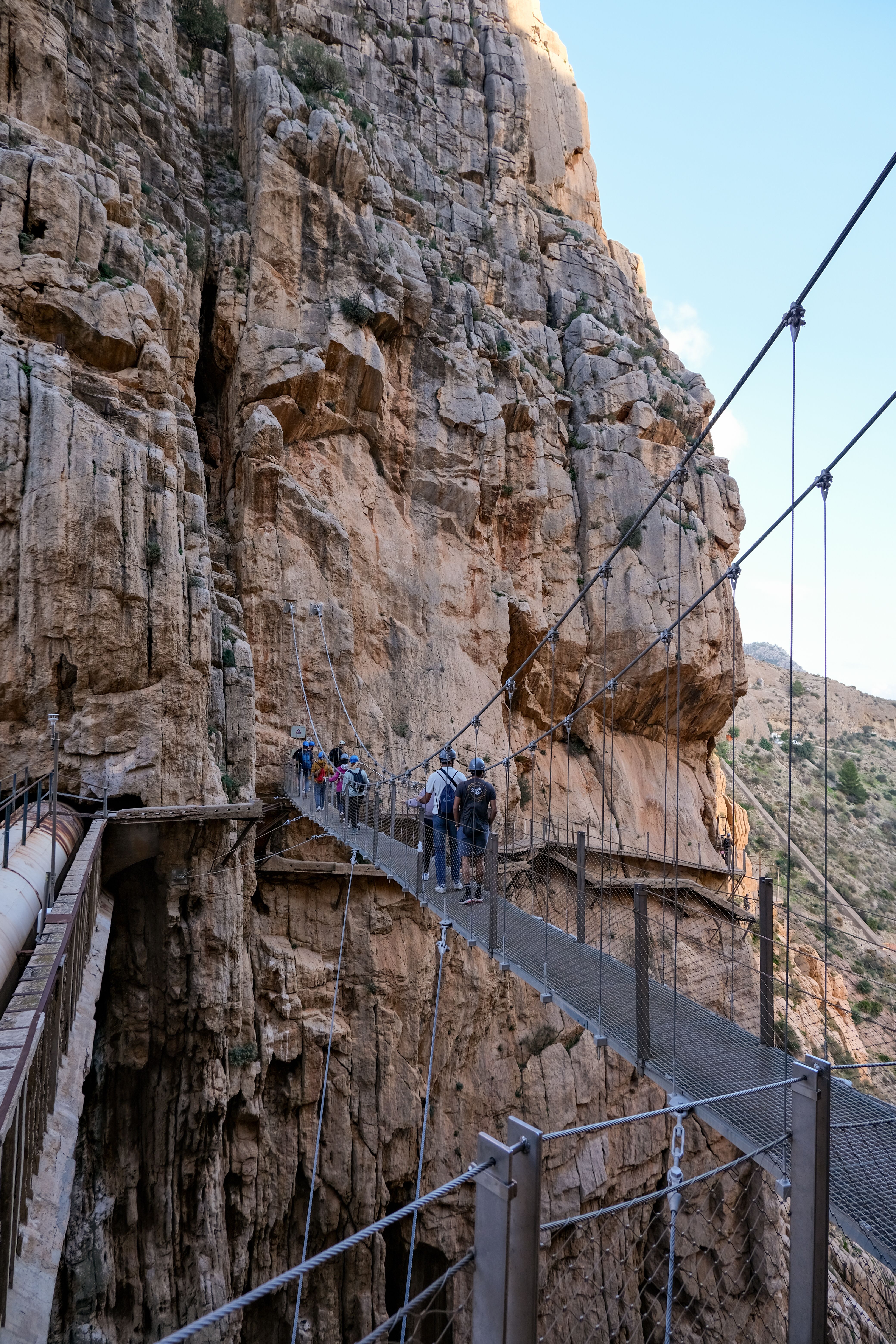 Hikers Crossing Caminito del Rey Bridge in Spain · Free Stock Photo