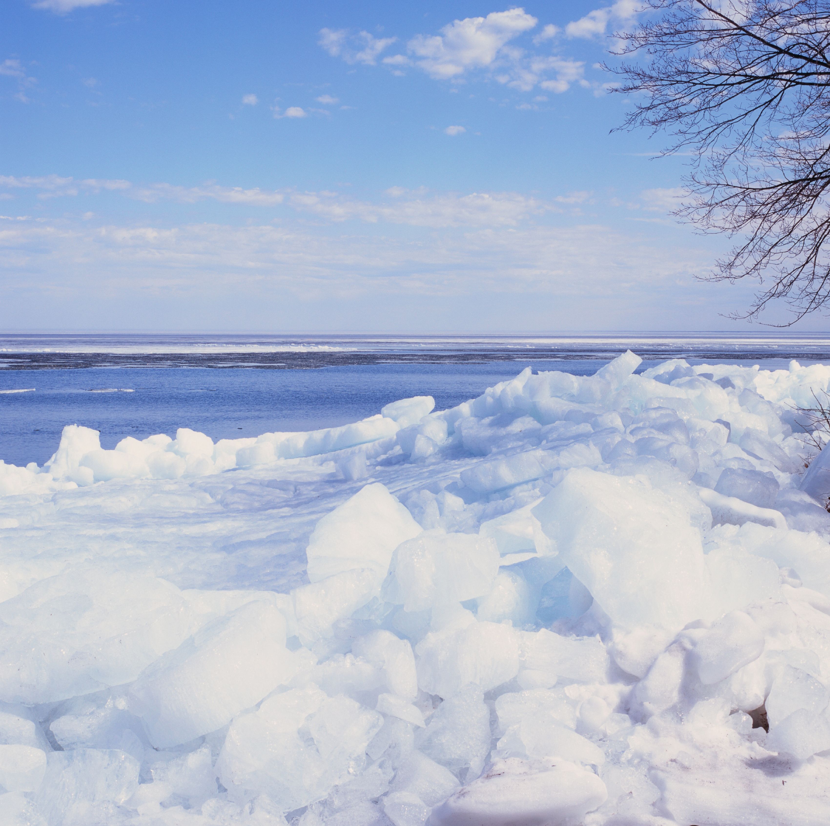 Experience stark beauty at a frozen lake in Minnesota. Capturing peaceful winter landscape with ice floes and blue sky.