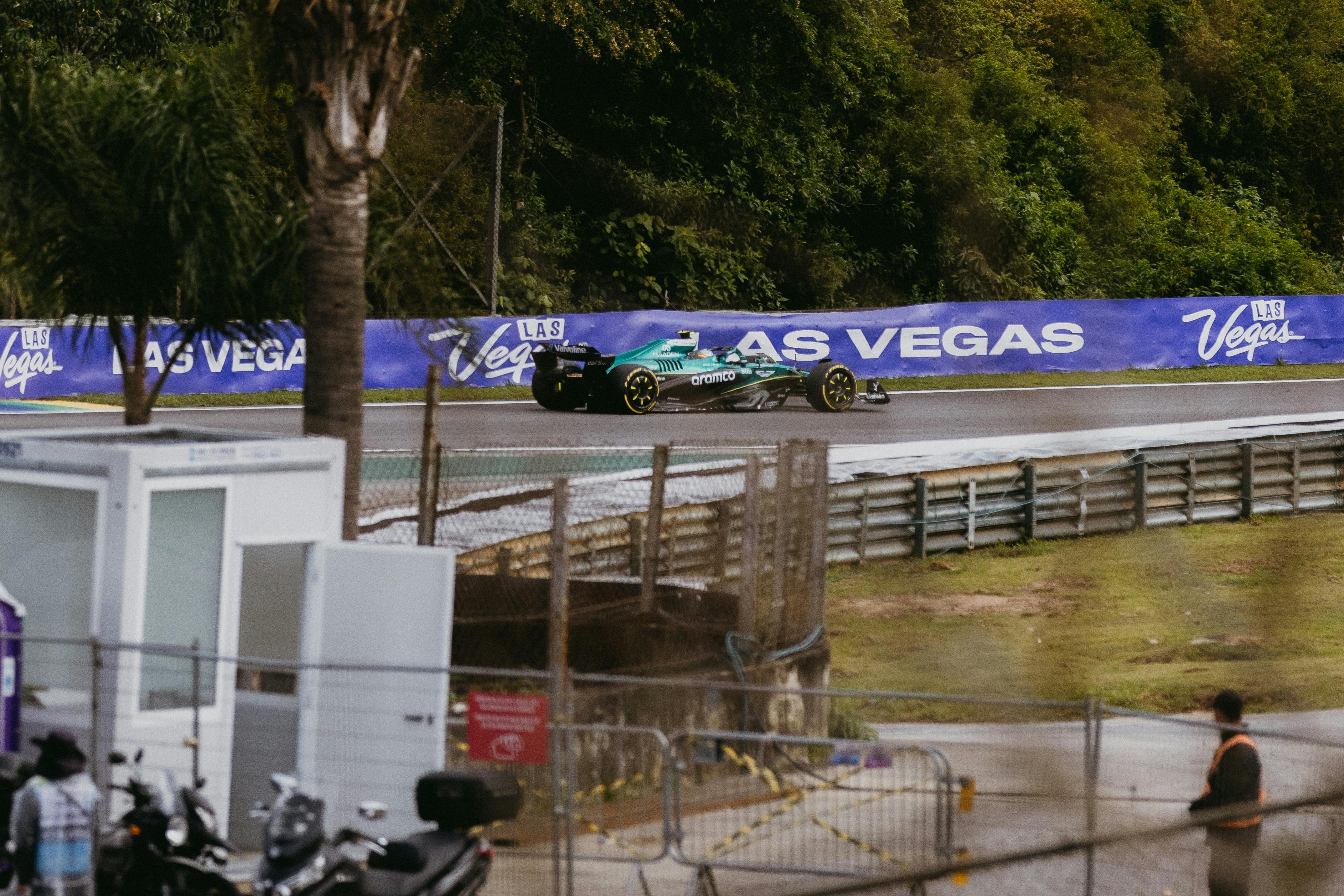A Formula 1 car races on a wet track at a São Paulo event, captured in action.