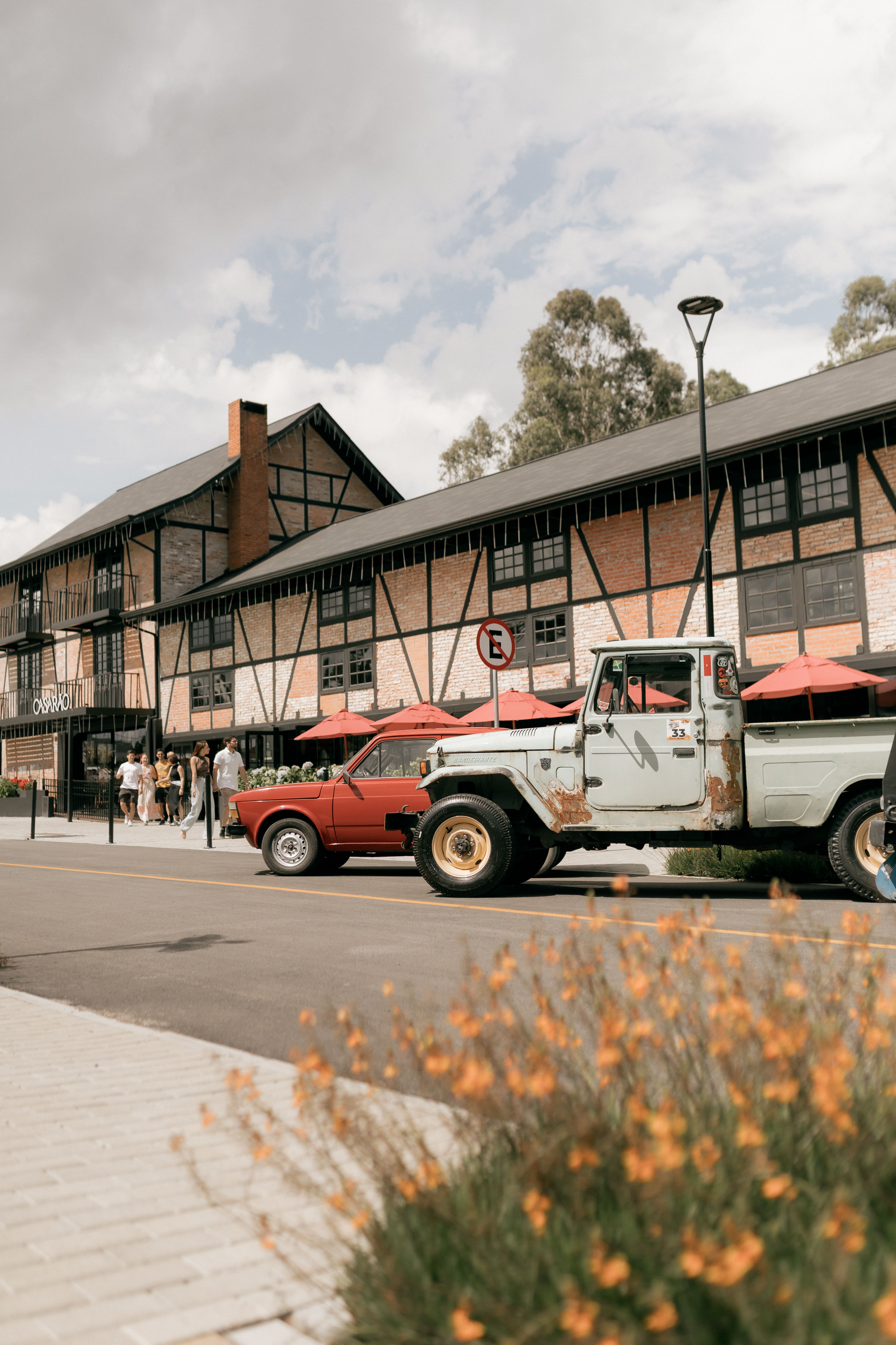 Vintage Trucks on Street in Front of Rustic Building · Free Stock Photo