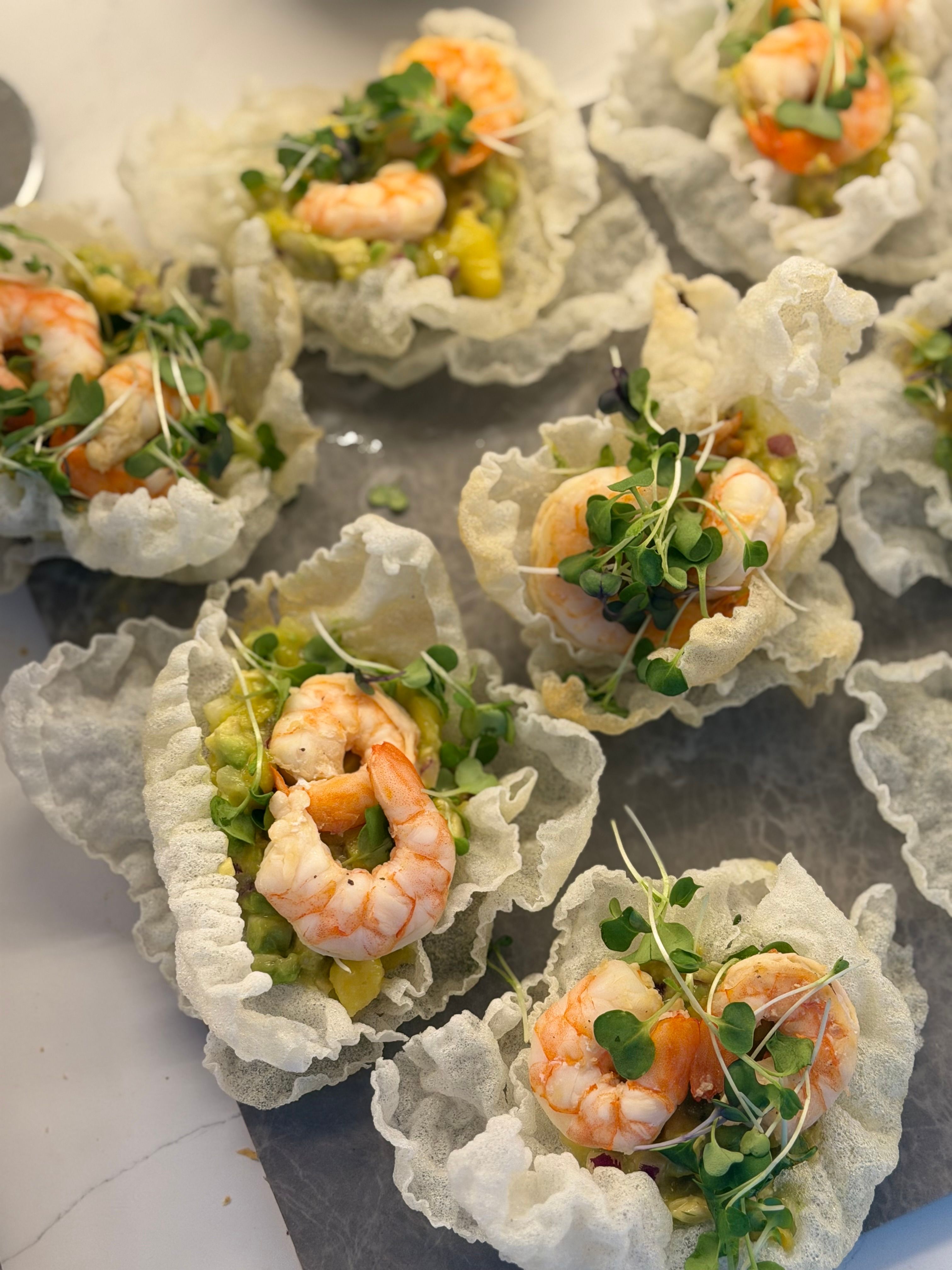 Tasty shrimp on crispy baskets with microgreens for a gourmet appetizer.