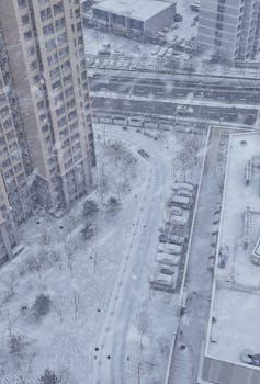 Aerial view of a snow-covered urban area in Beijing, capturing the tranquility of winter.