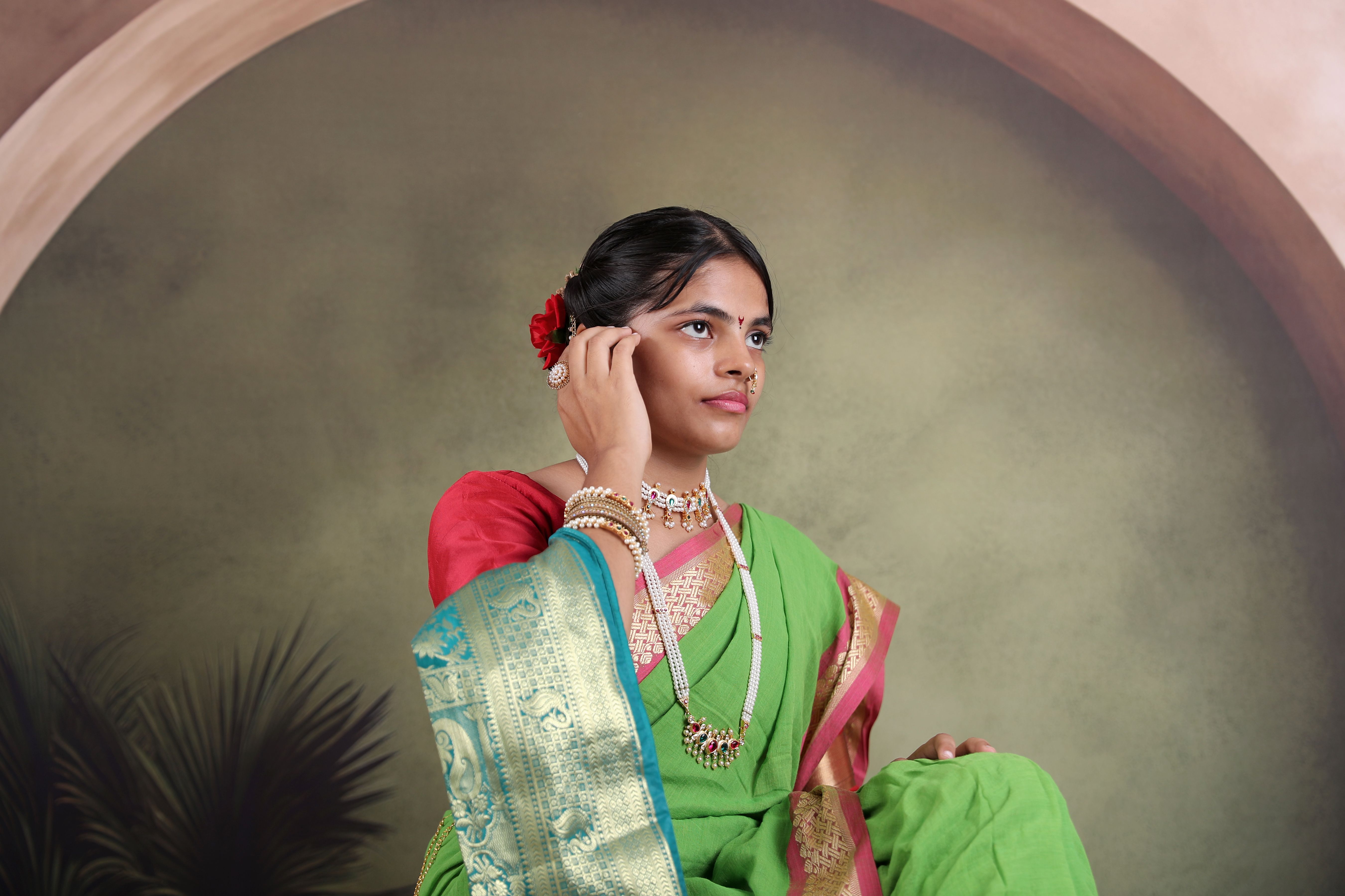Elegant Woman in Traditional Green Saree with Jewelry · Free Stock Photo