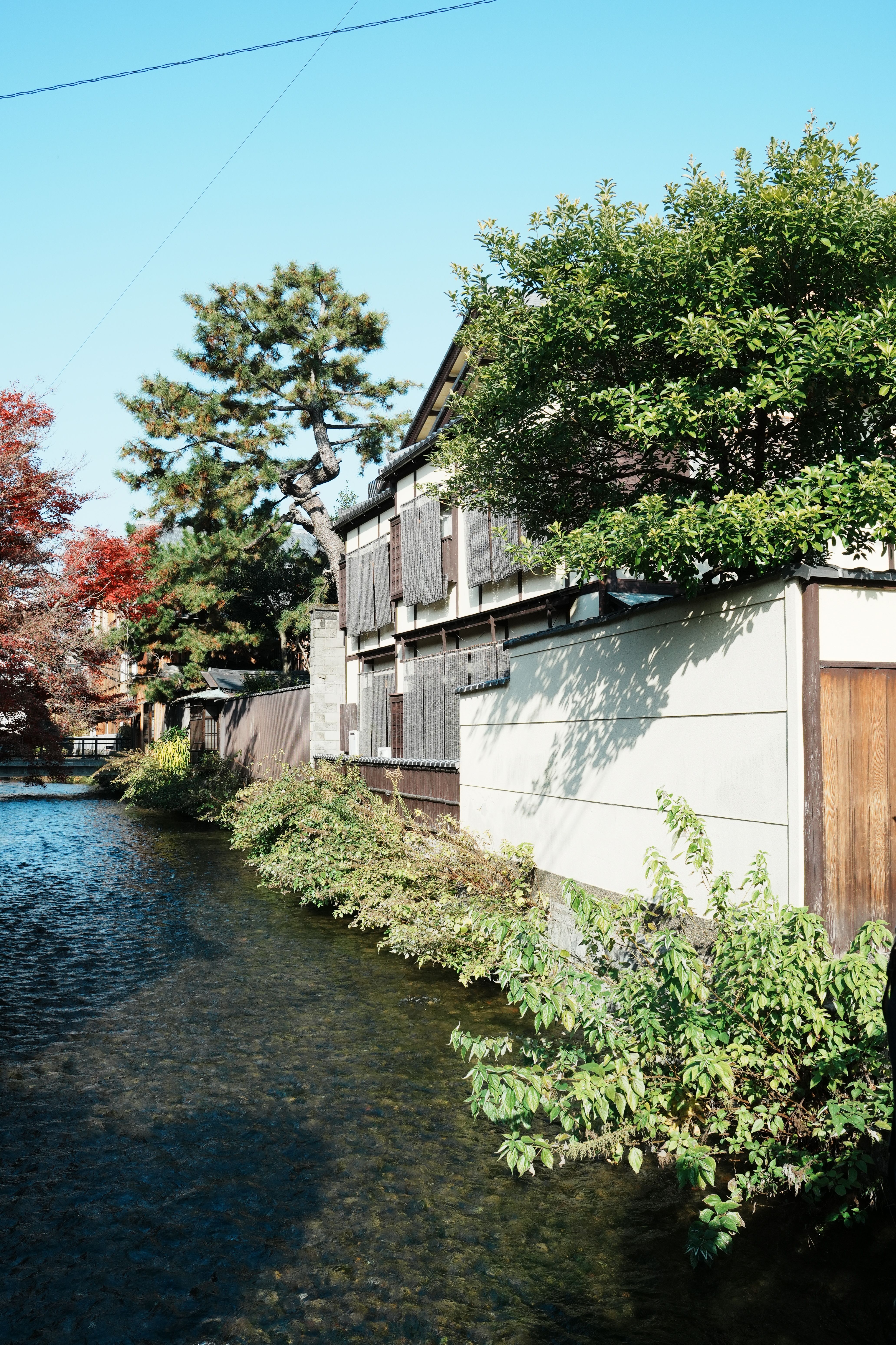Traditional Japanese Building by a Riverside in Kyoto · Free Stock Photo