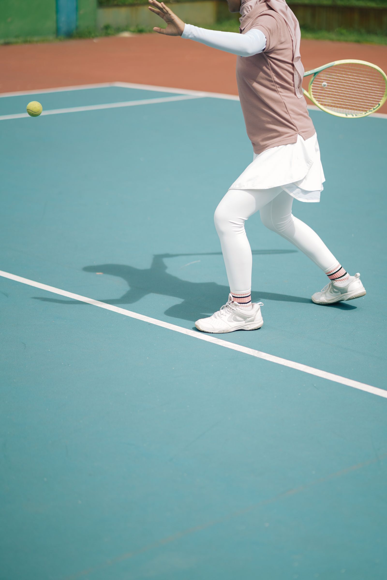 Tennis player hitting an aggressive shot during an outdoor match