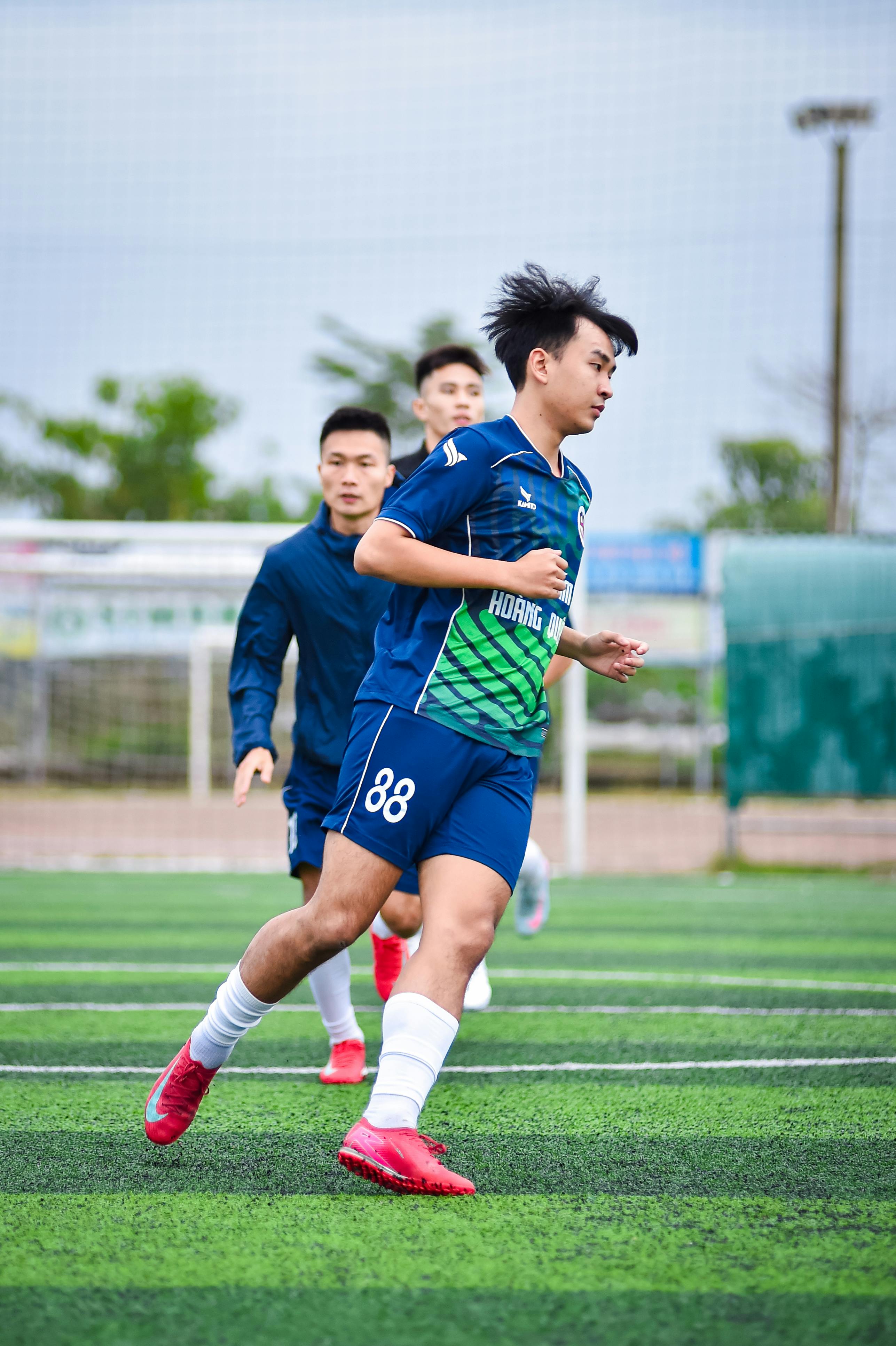 Vivid shot of football players practicing on artificial turf in Hanoi.