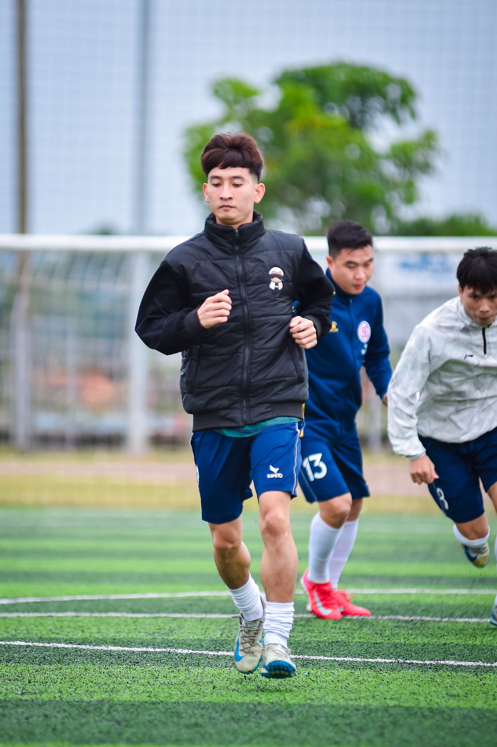 Young football players training on artificial turf