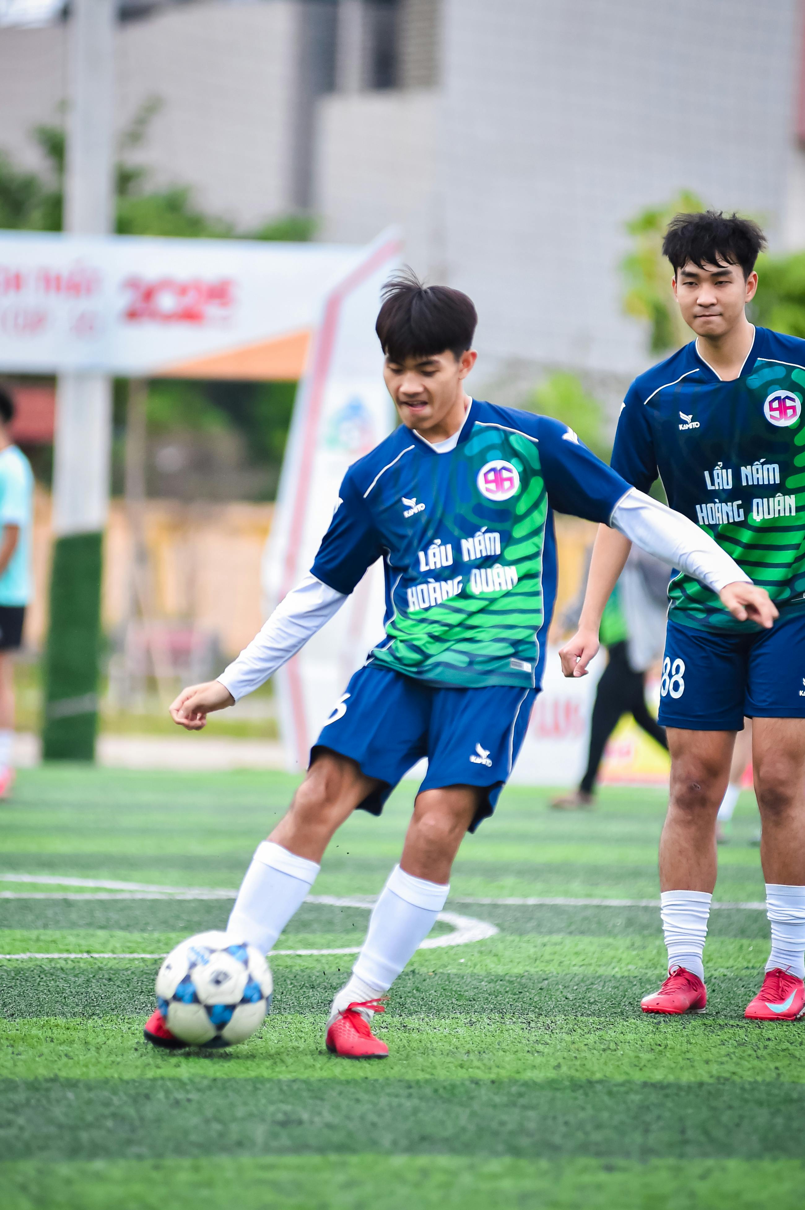 Young football players in action on an artificial turf in Hanoi, Vietnam.