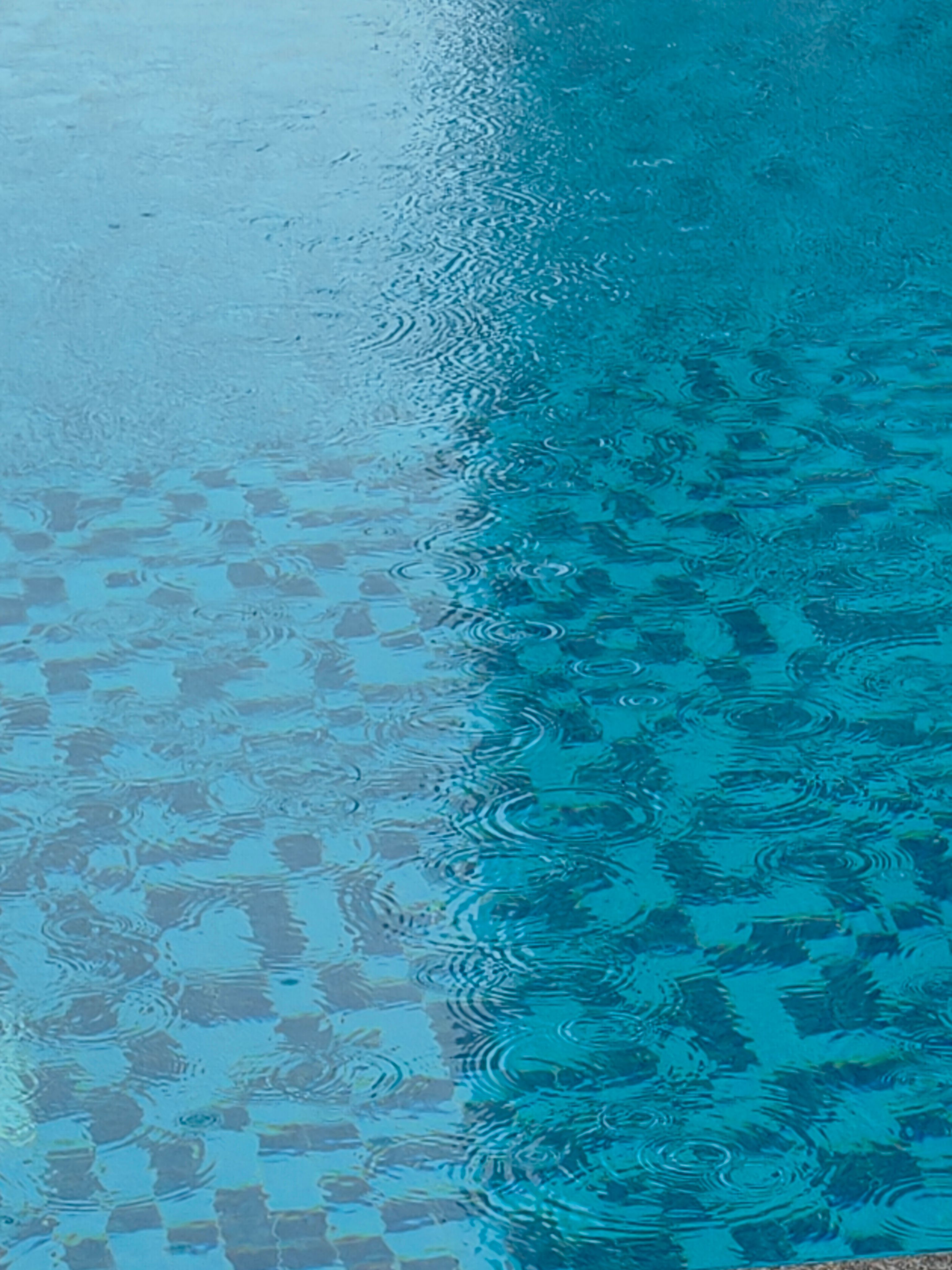 Blue Rippling Swimming Pool with Raindrops · Free Stock Photo