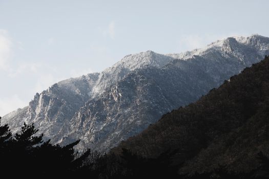 Majestic view of snow-dusted peaks in Seoraksan National Park on a clear winter day.
