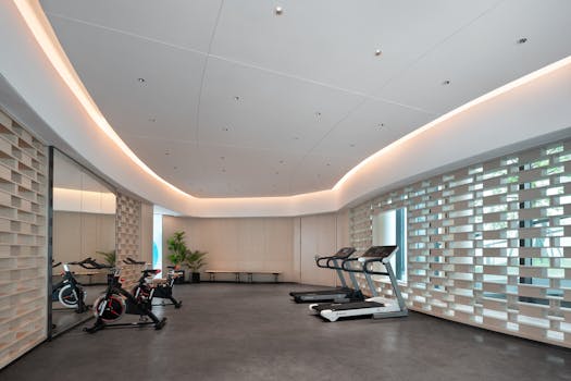 Spacious gym with modern fitness equipment and stylish decor.