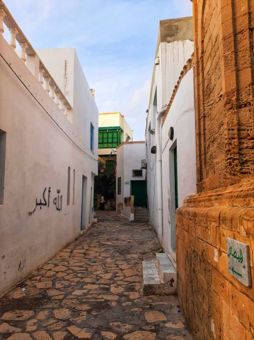Free Explore the picturesque narrow alleyways of an ancient city medina, showcasing white and stone architecture. Stock Photo