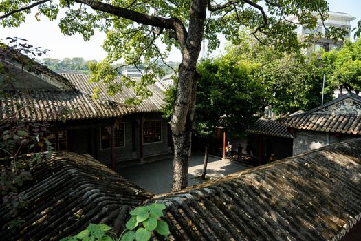 Serene view of a traditional courtyard with historic Chinese architecture and lush greenery.