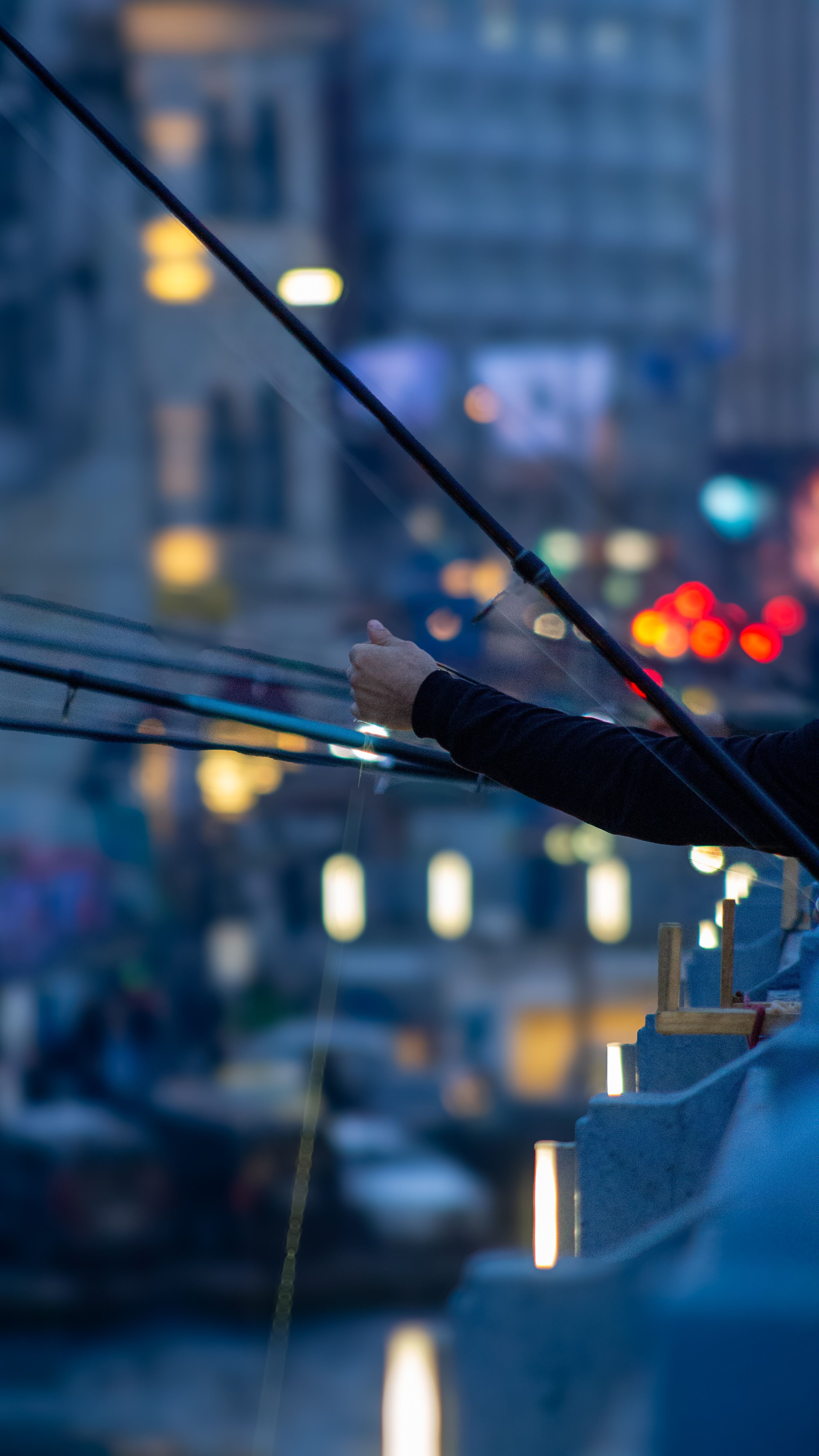 Evening Street Scene with Fishing Rods on Bridge · Free Stock Photo