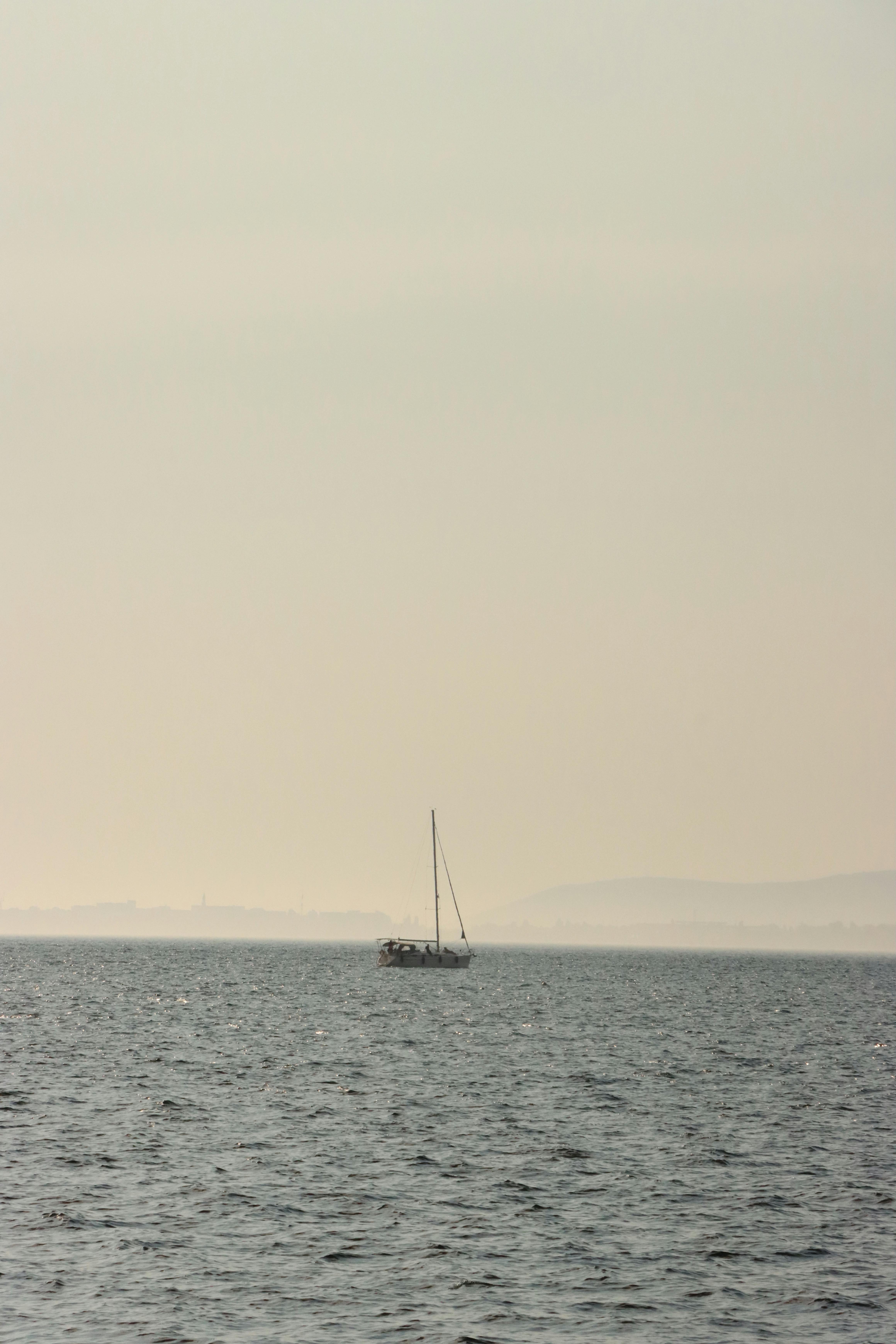 A serene sailboat drifting on the calm waters off the coast of Kocaeli, Türkiye.