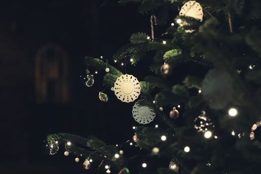 Elegant Christmas tree with lights and ornaments beautifully illuminated at night.