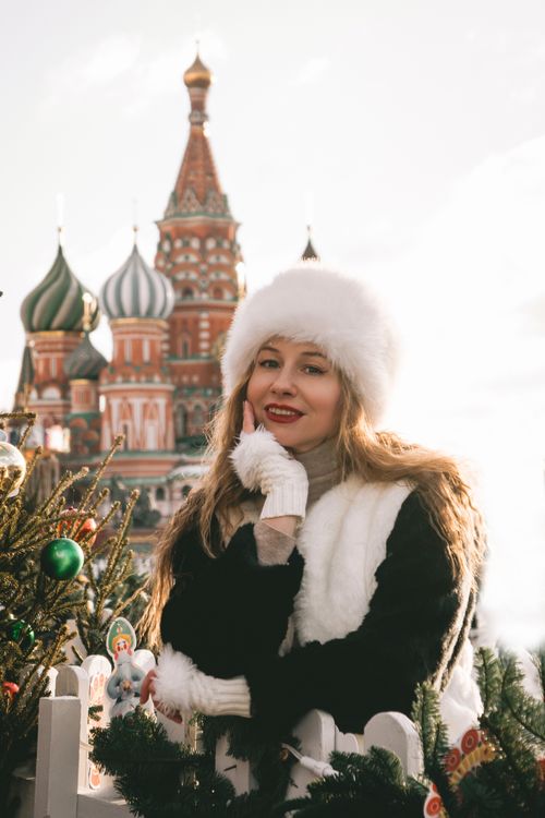 Free Woman in winter attire posing with St. Basil's Cathedral in Moscow. Stock Photo