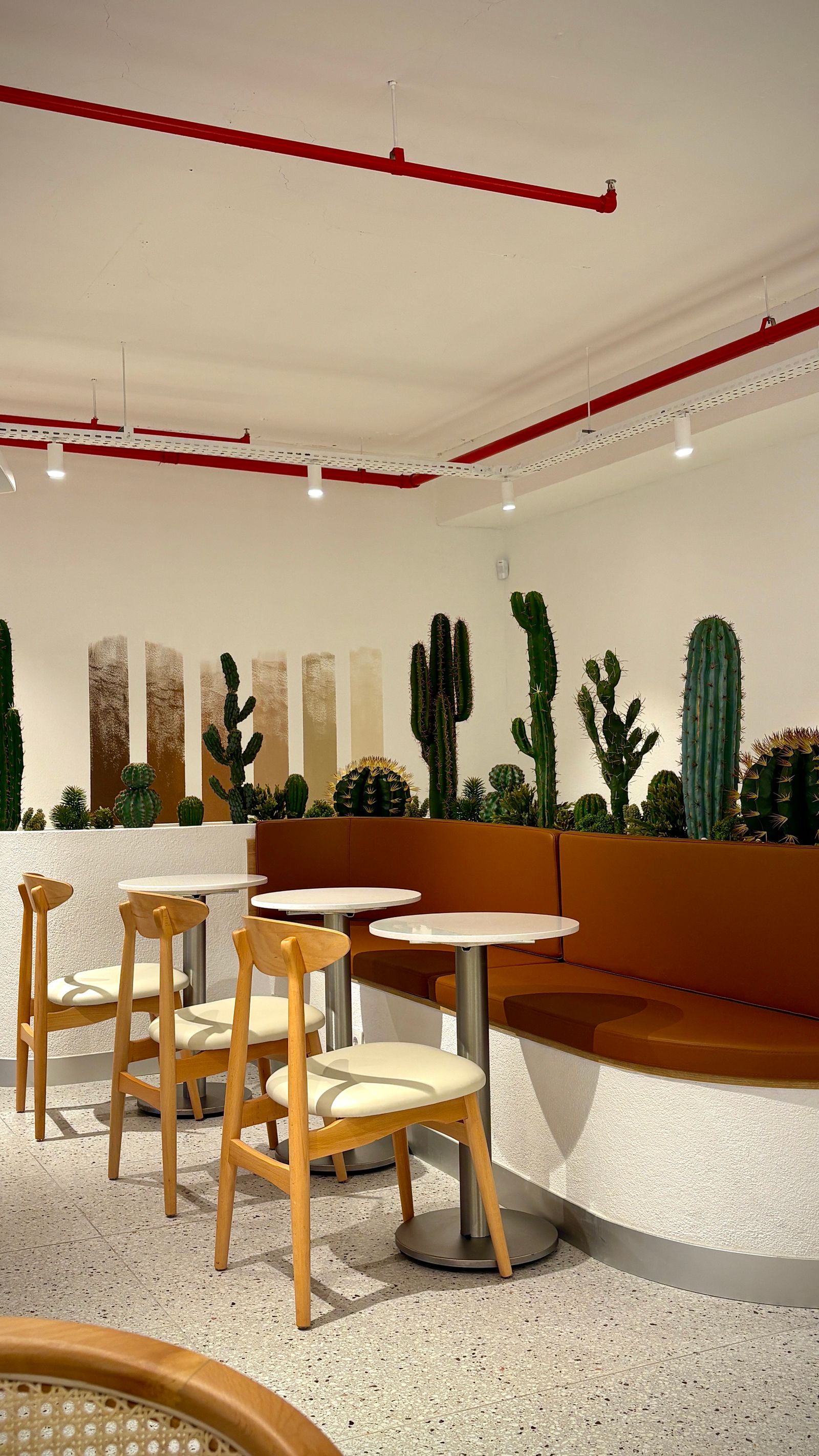 Café seating zone with guests enjoying the Copperline interior