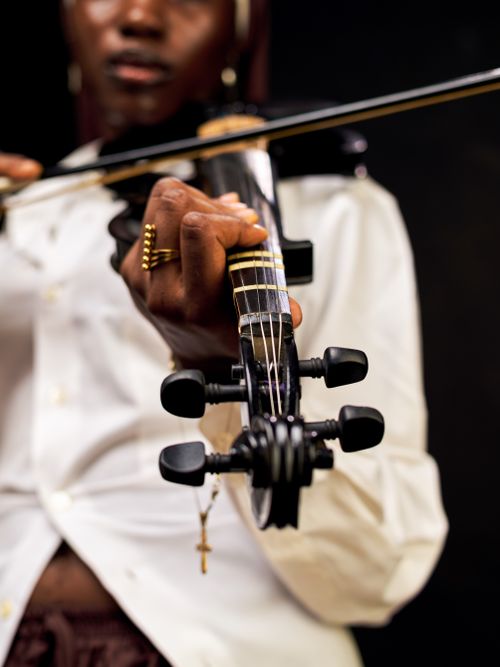 Free Focused close-up shot of an electric violin being played by a talented musician. Stock Photo
