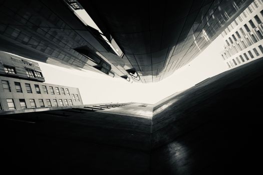 A striking upward view of urban architecture with modern skyward perspective.