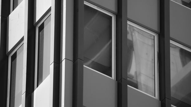 Detailed close-up of a modern building facade in black and white photography.
