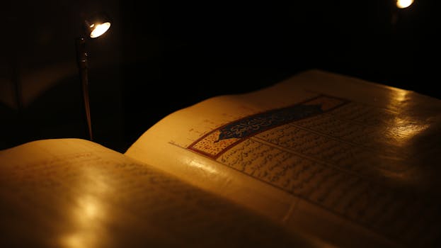 Close-up of an ancient manuscript illuminated by warm light, rich with historic detail.