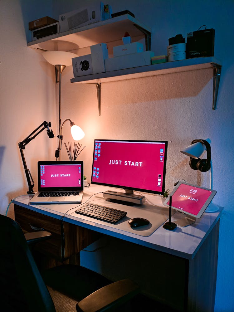 Computer Monitor And A Laptop On A Table