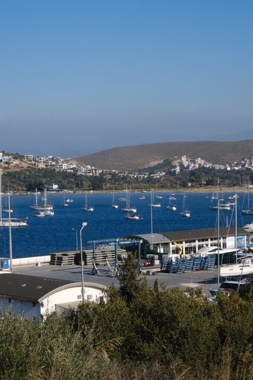 Free Tranquil view of a harbor with sailboats in Sığacık, İzmir, Türkiye under a clear blue sky. Stock Photo