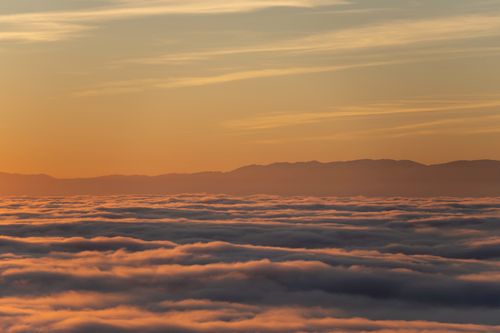 Free A breathtaking view of clouds over Lausanne with a golden sunset in the background. Stock Photo