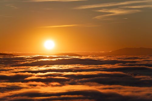 Free Breathtaking sunset view above the clouds over Lausanne, Switzerland. Warm and golden tones illuminate the sky. Stock Photo