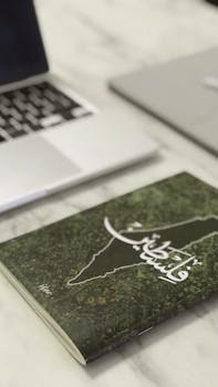 Elegant minimalist workspace with laptop and book showcasing smart technology and thoughtful design.