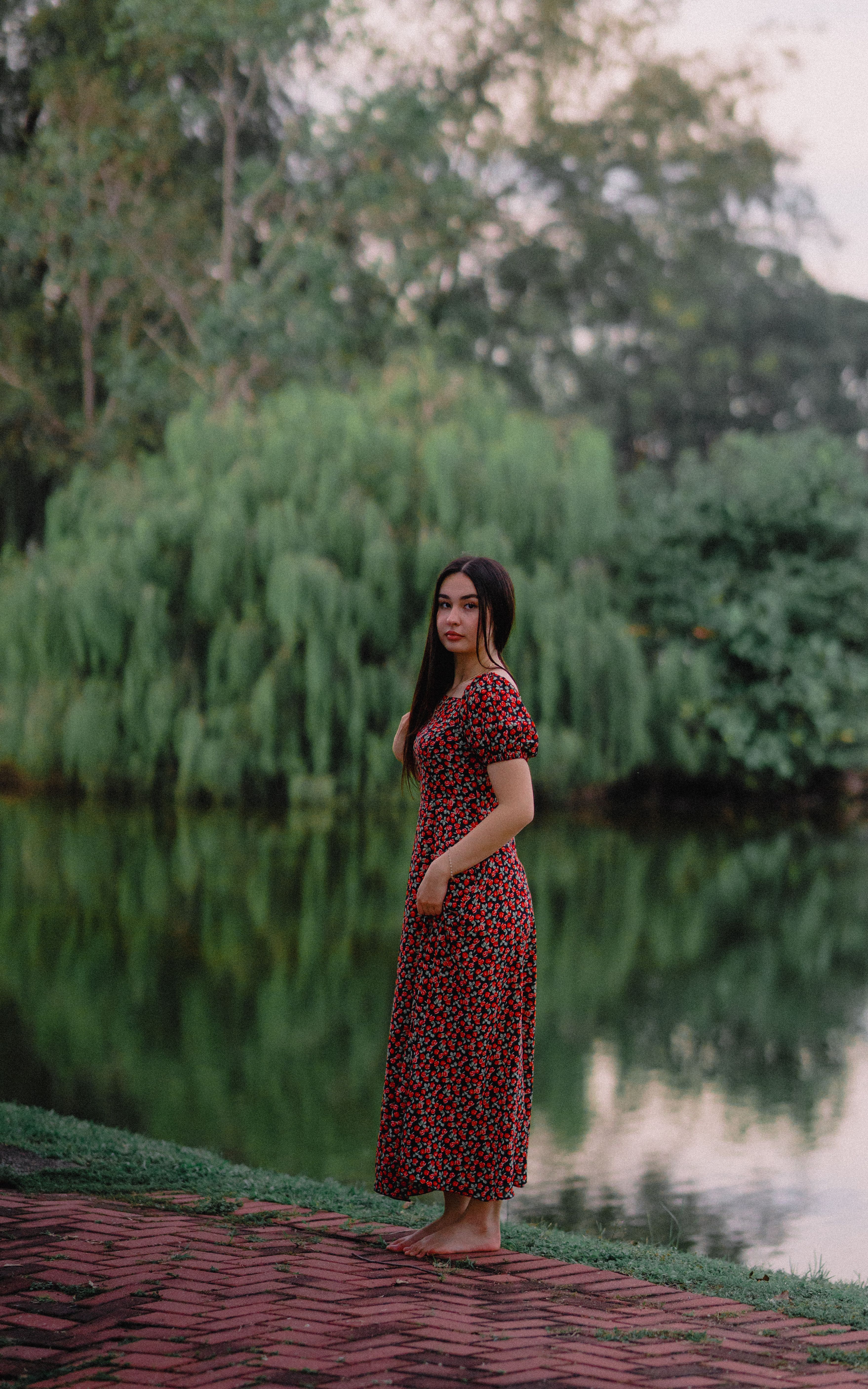 Woman in Floral Dress by Serene Lakeside · Free Stock Photo